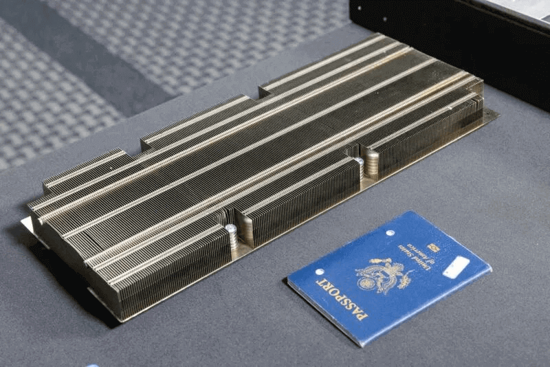 This heat sink, shown with an expired passport for scale